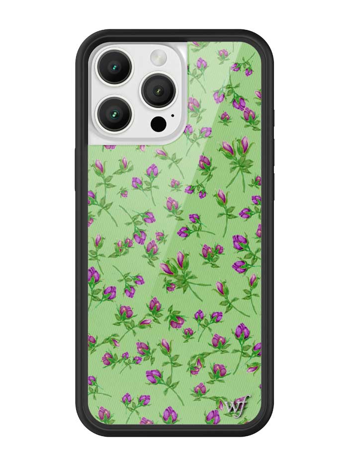 Close up of a purple floral patterned iPhone case with green background and protective black bumper