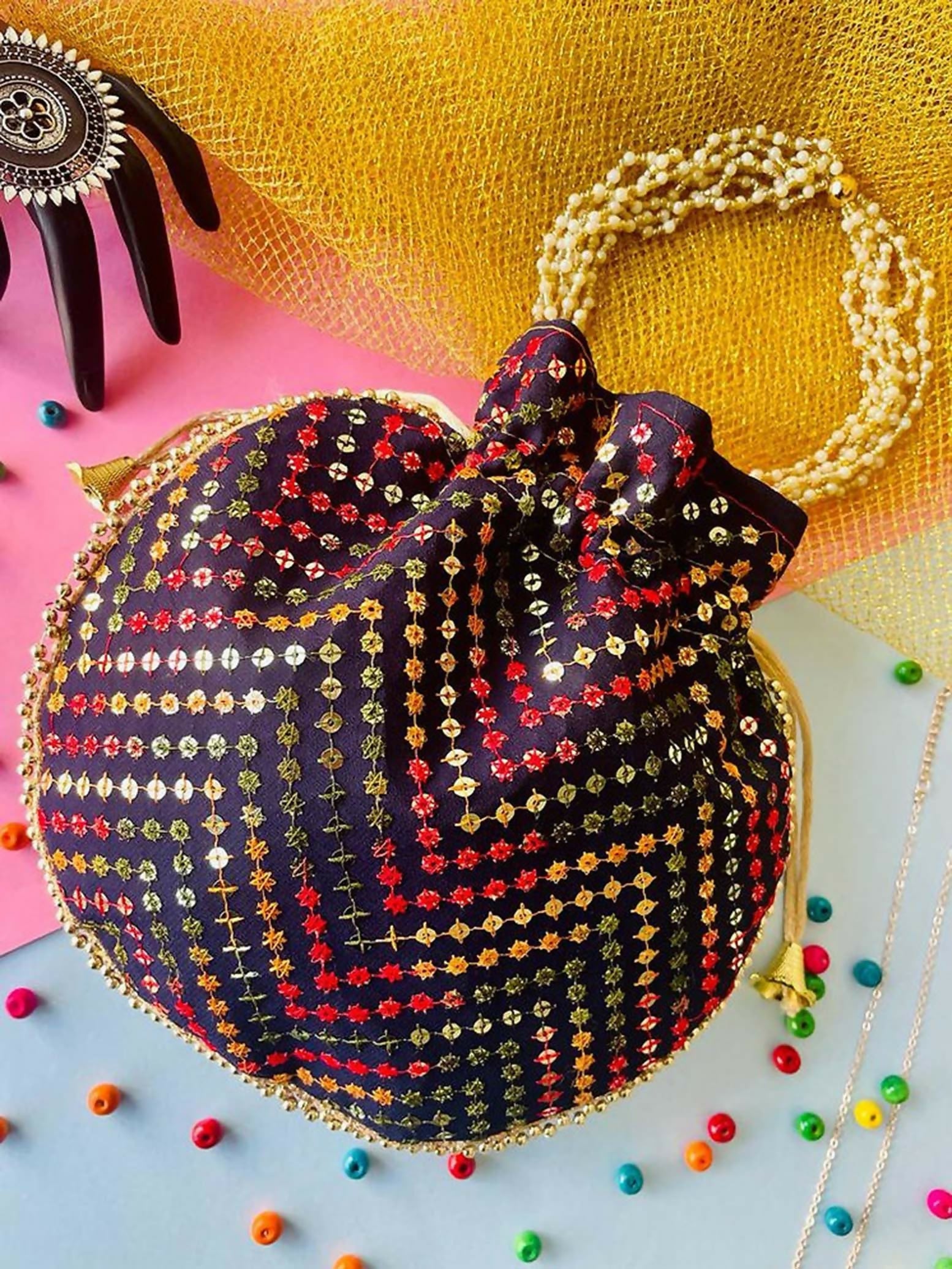 Multicolor geometric print potli bag with drawstring, ideal for ethnic wear and weddings.