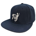 A navy blue snapback hat featuring the NJ scripture logo in high-contrast lettering.