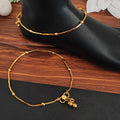 Close-up of ornate Indian traditional antique gold polish anklets for girls