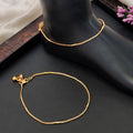 Close up of an elegant high-gold polish anklet for girls with delicate stone detailing