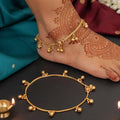 Traditional gold-toned ghungroo dangle anklet for girls on a neutral background