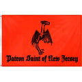 A vibrant orange and black Jersey Devil Patron Saint flag hanging on a wall as alternative home decor.