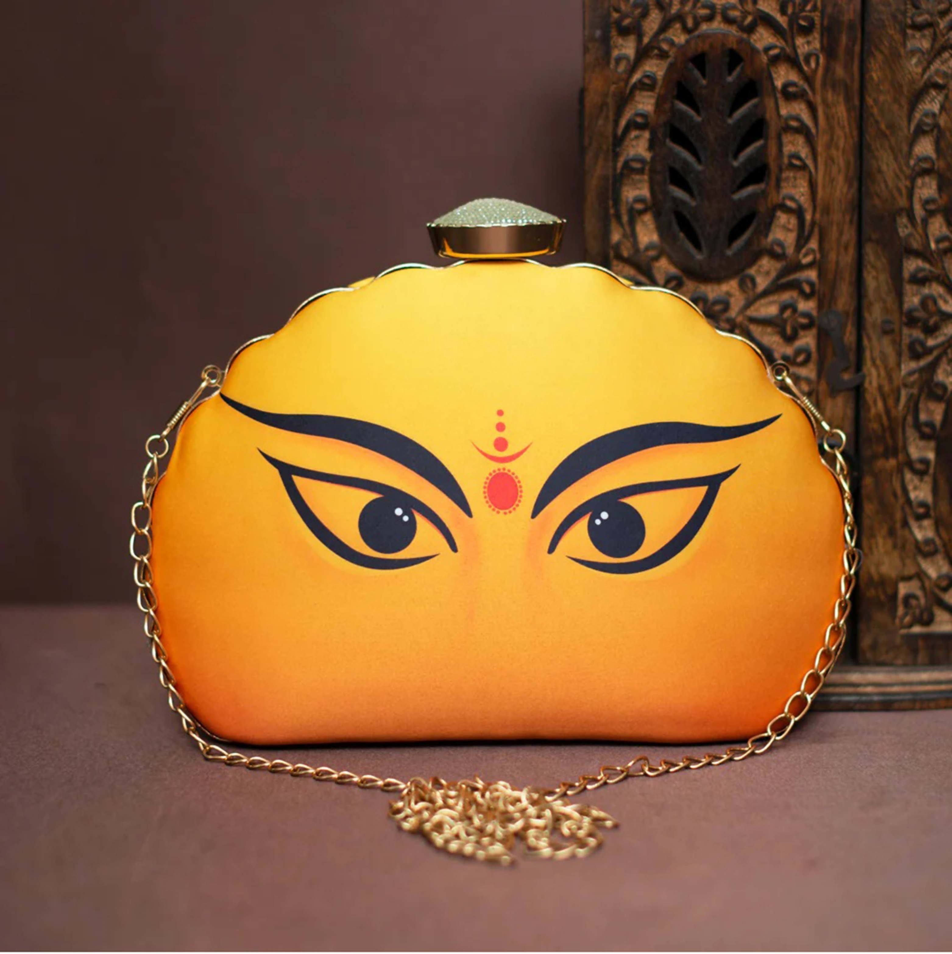 Vibrant yellow D-shape clutch with unique Durga Eyes print
