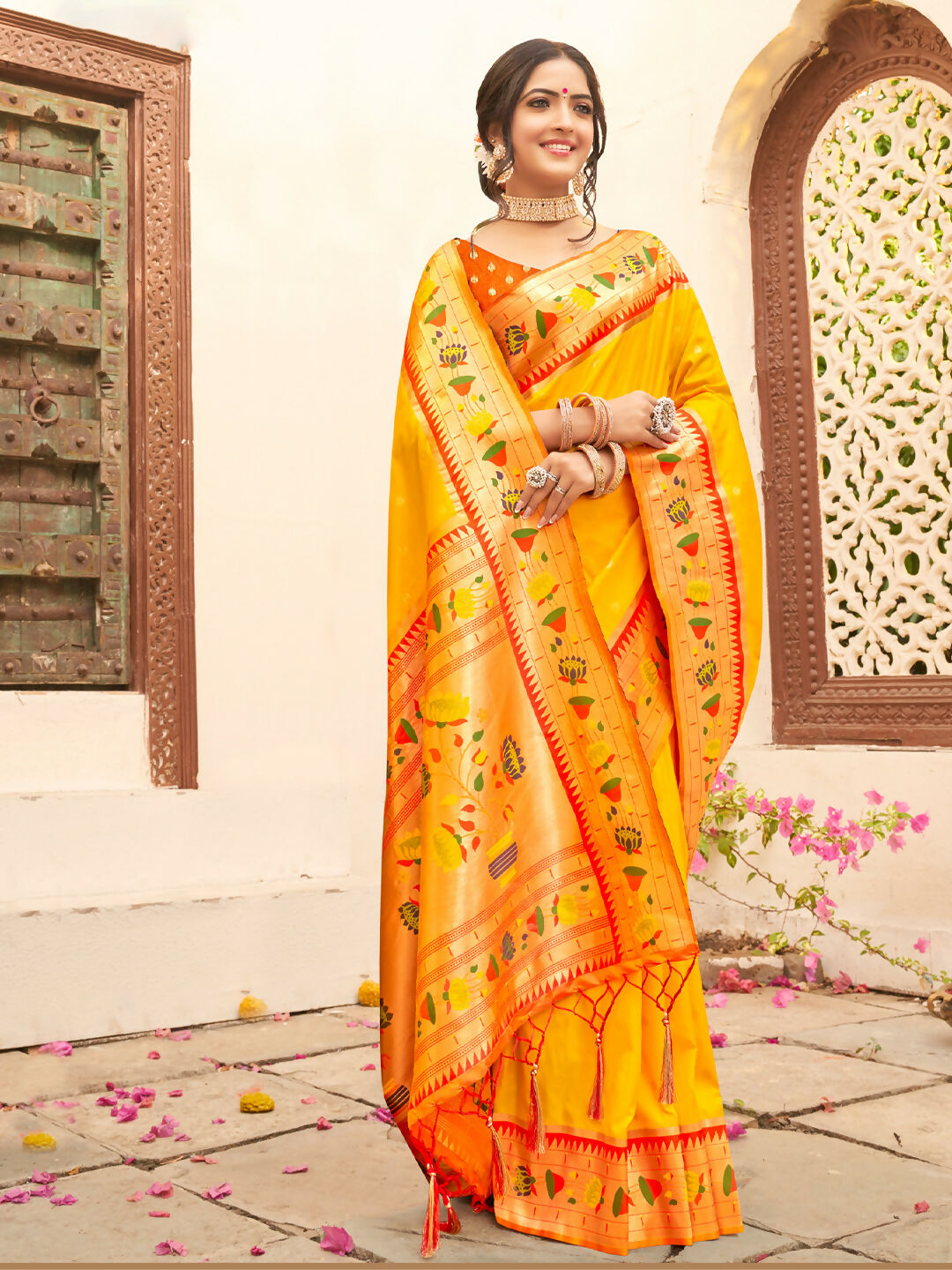 Vibrant yellow silk blend saree with contrast orange blouse for festive wear