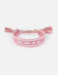 Pink woven fabric bracelet with What Would Jesus Do embroidered text