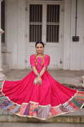 A pink Roman silk gown adorned with intricate mirror work and Maslin crochet print details.
