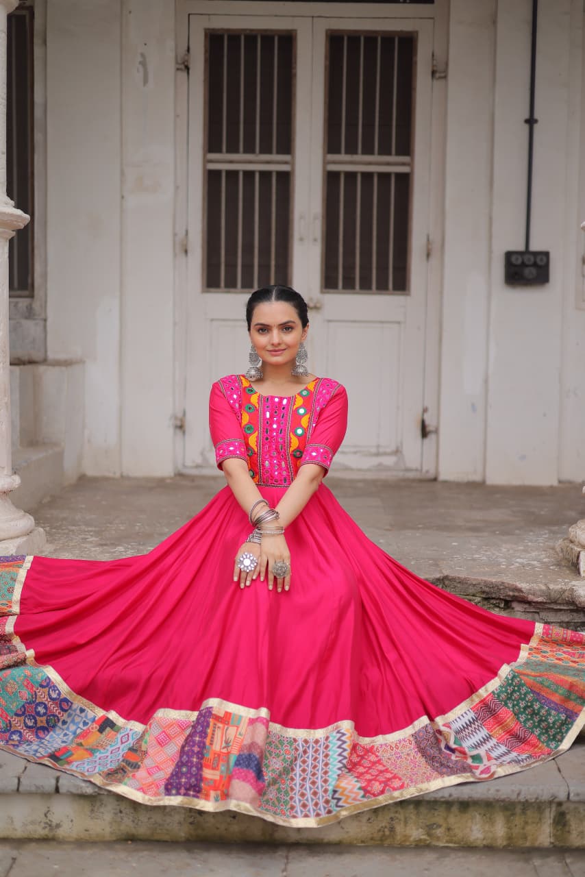 A pink Roman silk gown adorned with intricate mirror work and Maslin crochet print details.