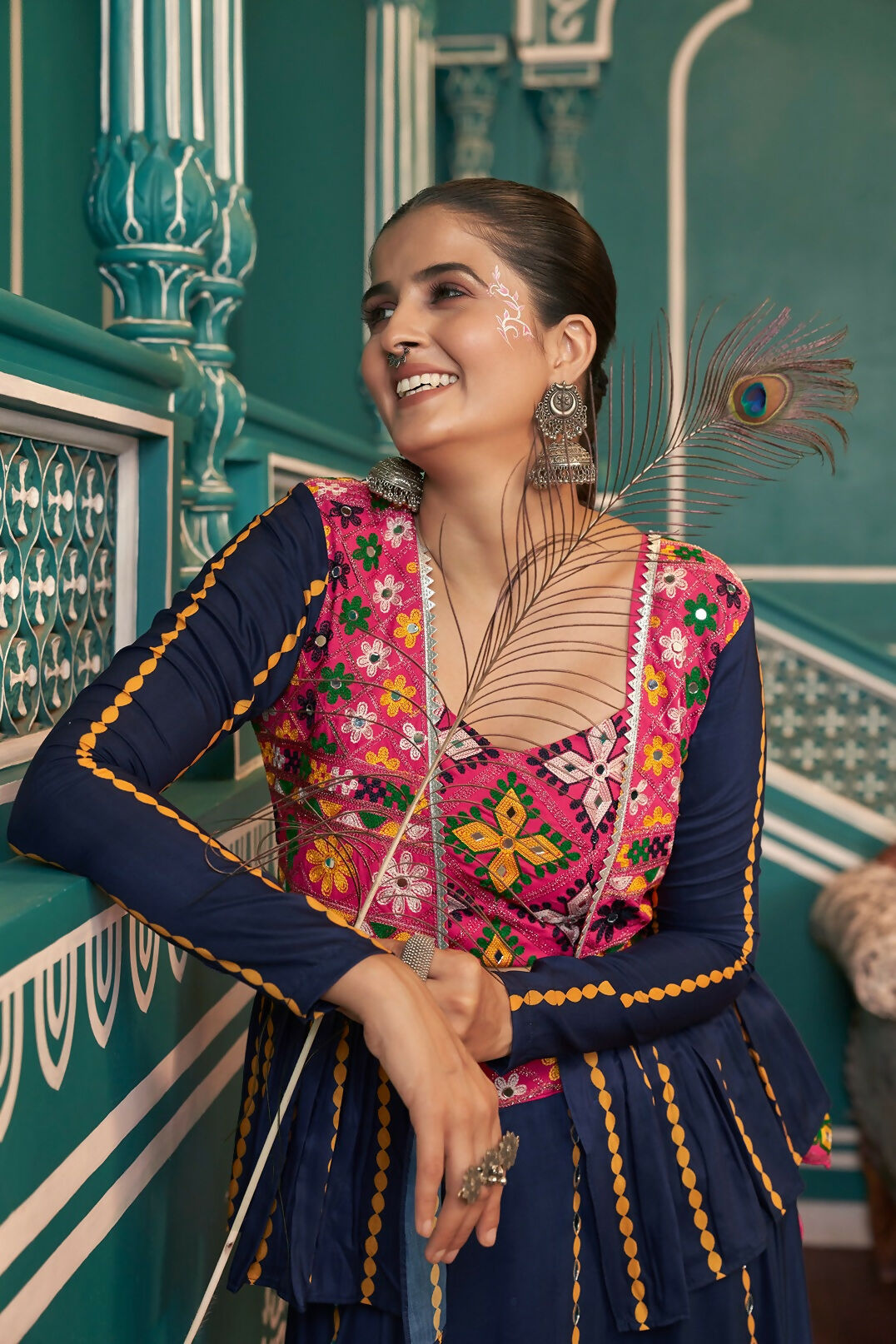 Woman wearing a multi-color bohemian style floor-length lehenga choli with navy blue accents