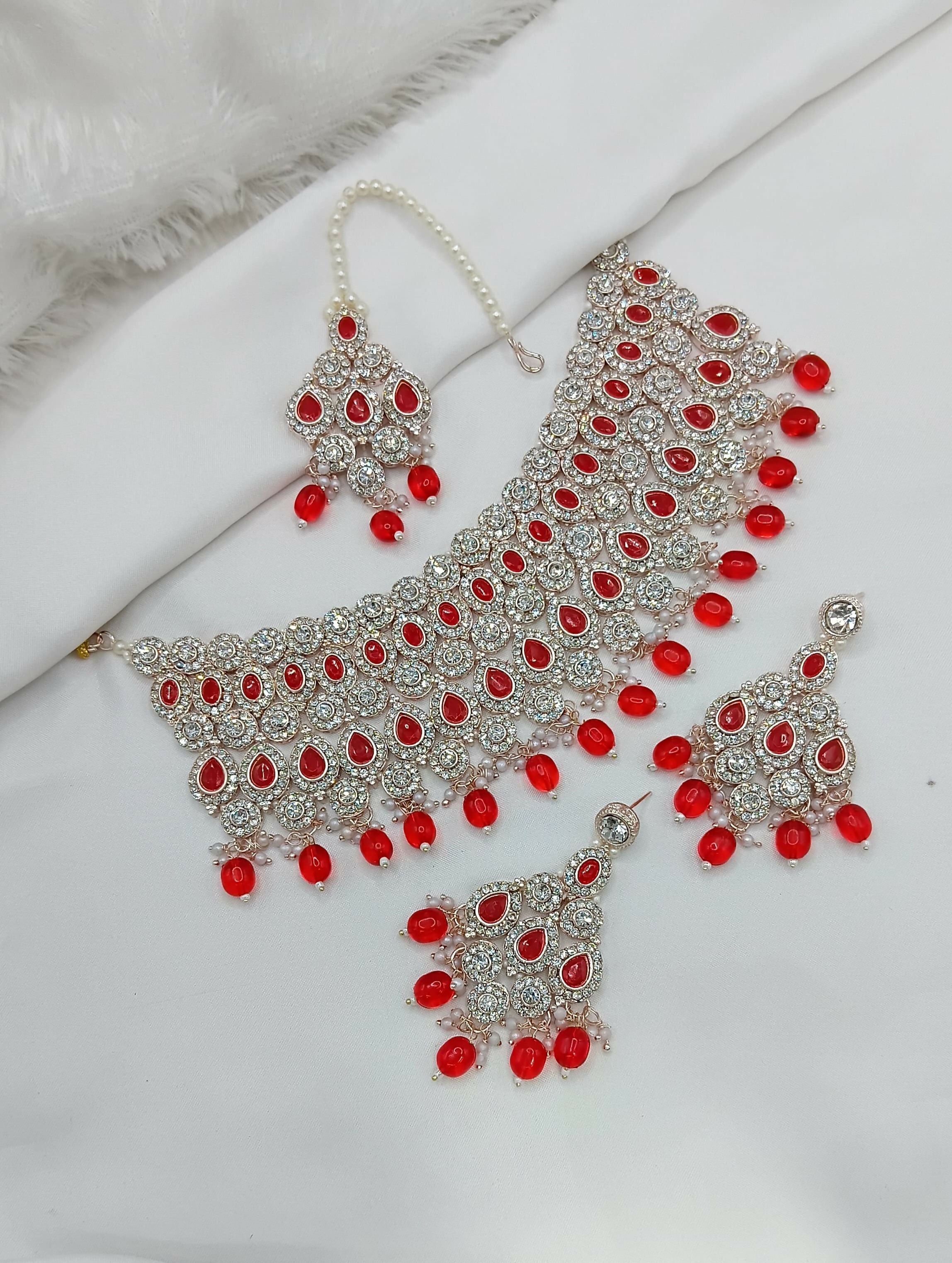Vibrant red stone work necklace set with matching tikka and earrings