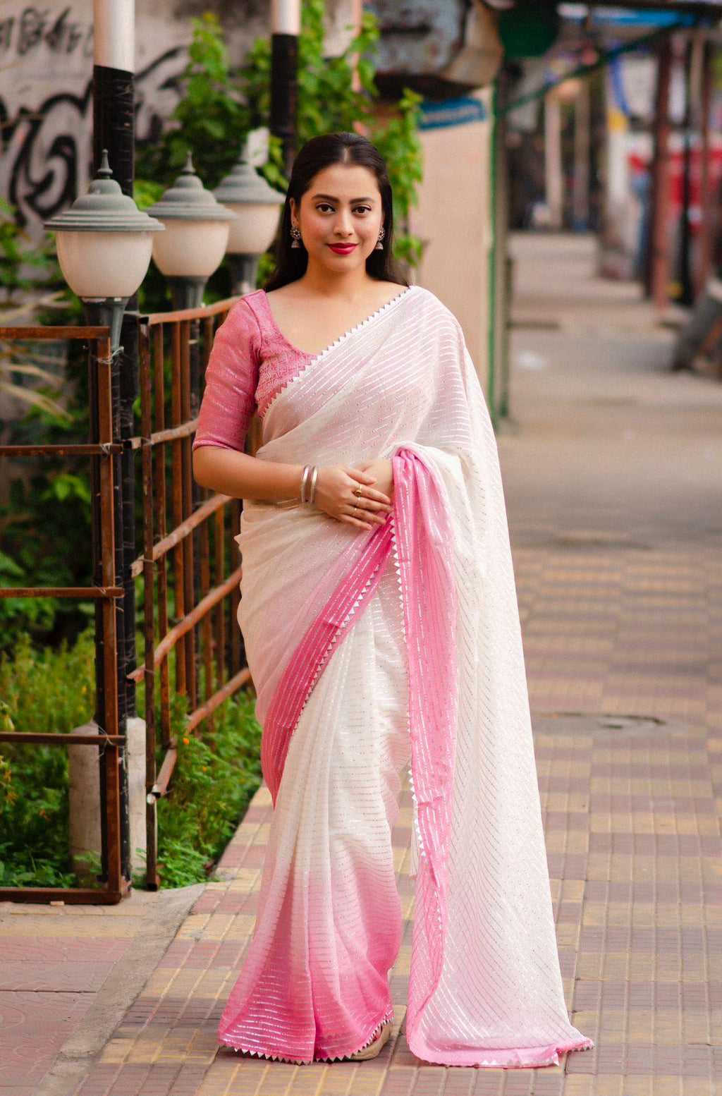 Pink poly chiffon striped saree with silver zari lining and patola blouse