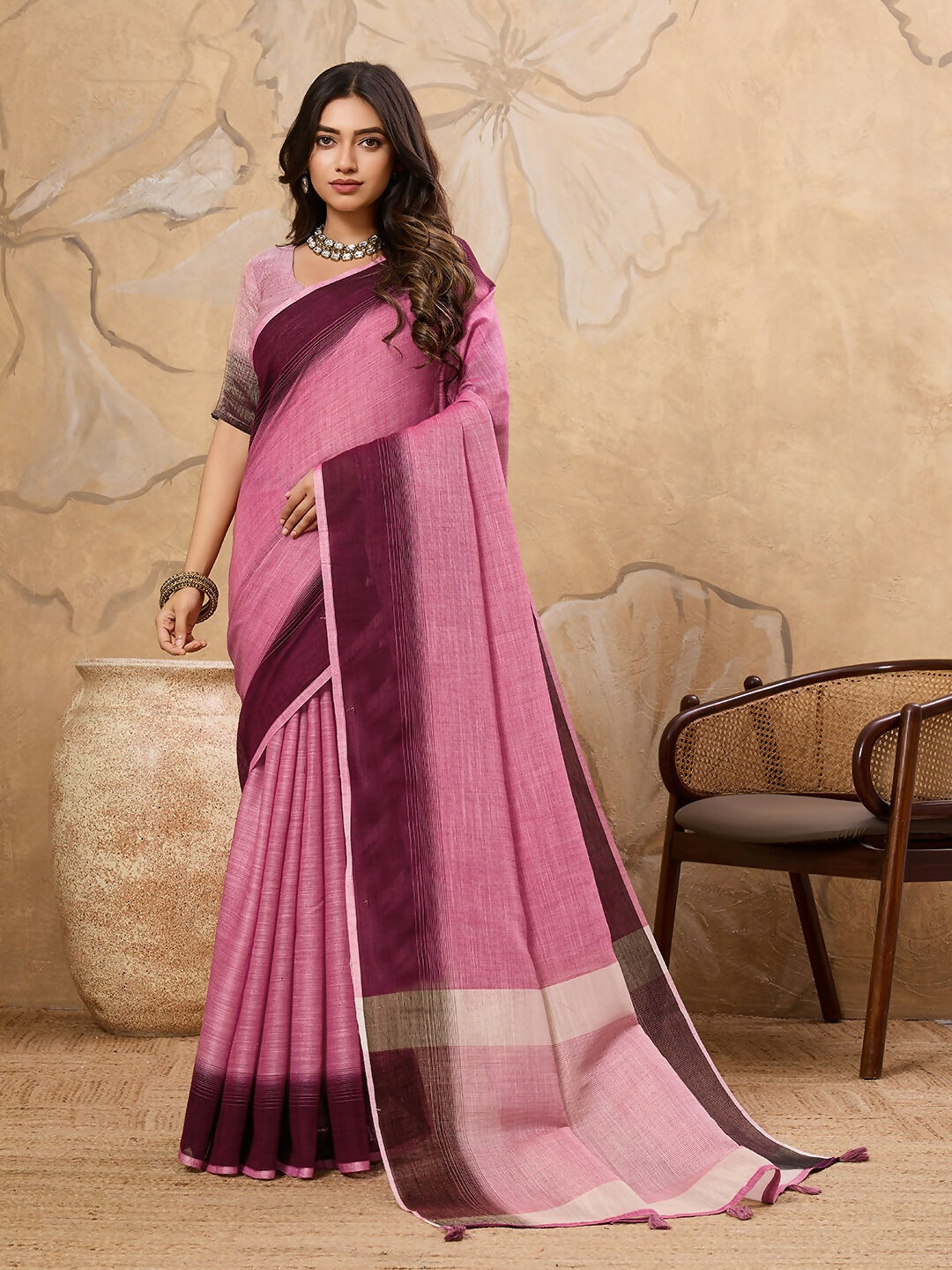 A beautiful Rani Pink linen saree with matching blouse draped elegantly.
