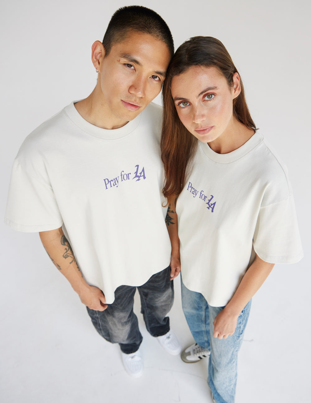 Oversized off-white heavyweight cotton tee with purple Pray for Los Angeles graphic text and gold rose detail
