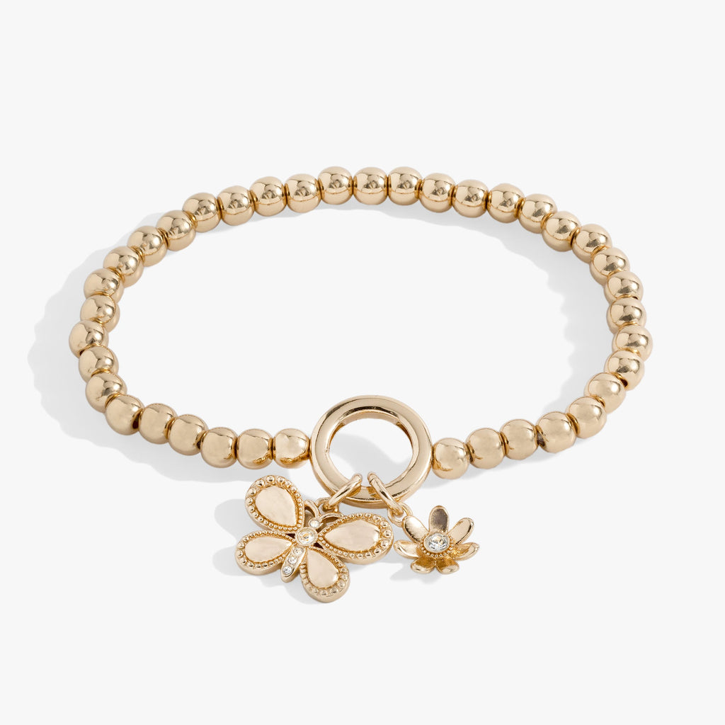 Gold puffy butterfly stretch bracelet with crystal details and a daisy charm