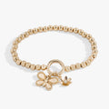 Gold puffy butterfly stretch bracelet with crystal details and a daisy charm