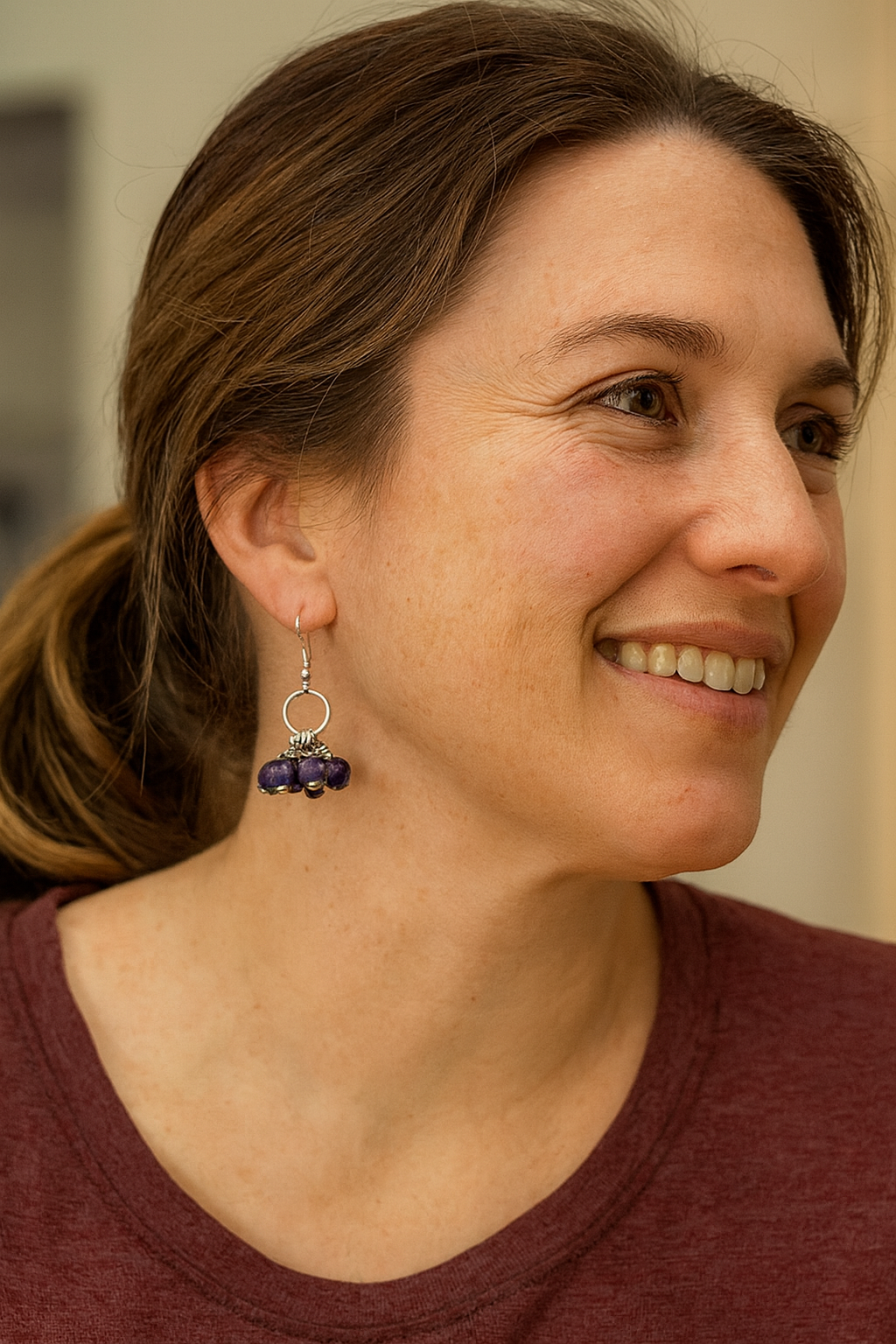 Close-up of vibrant blue handmade Mukaaga paper bead earrings with polished silver accents and hook closures.
