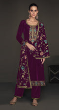 Close up of purple velvet fabric with intricate embroidery and sequence details