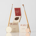 The Eye-Lift Kit featuring cream, brown, champagne, and beige eyeshadow shades in a minimalist compact.