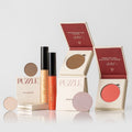 The Glow & Go Set featuring nude, bronze, and coral highlighter and eyeshadow