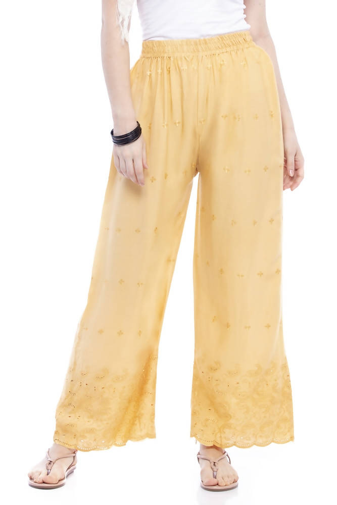 Close up of dark golden palazzo pants with intricate Chikan embroidery detail.