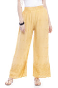 Close up of dark golden palazzo pants with intricate Chikan embroidery detail.