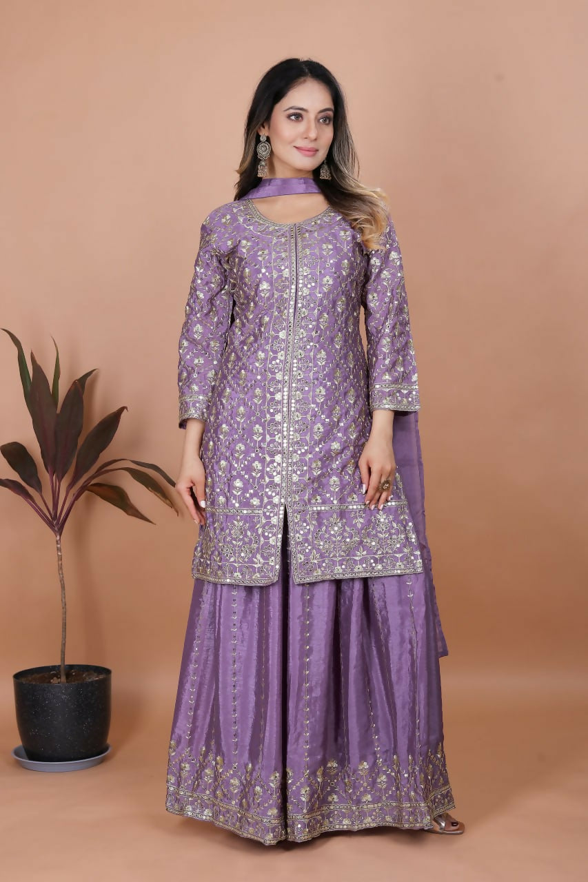 A elegant purple silk embroidered kurti paired with matching sharara pants.