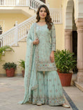 Woman wearing a sky blue embroidered georgette kurti and sharara pants set