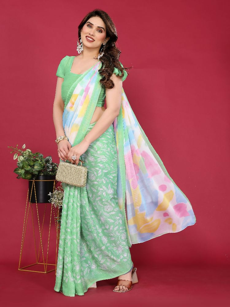 Pista green moss chiffon saree with abstract prints in yellow, pink, and sky blue, worn by a woman.