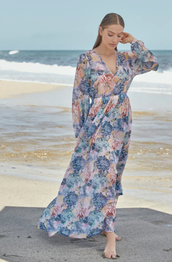 A sheer, floral print maxi beach coverup with long sleeves and ruffled trim.
