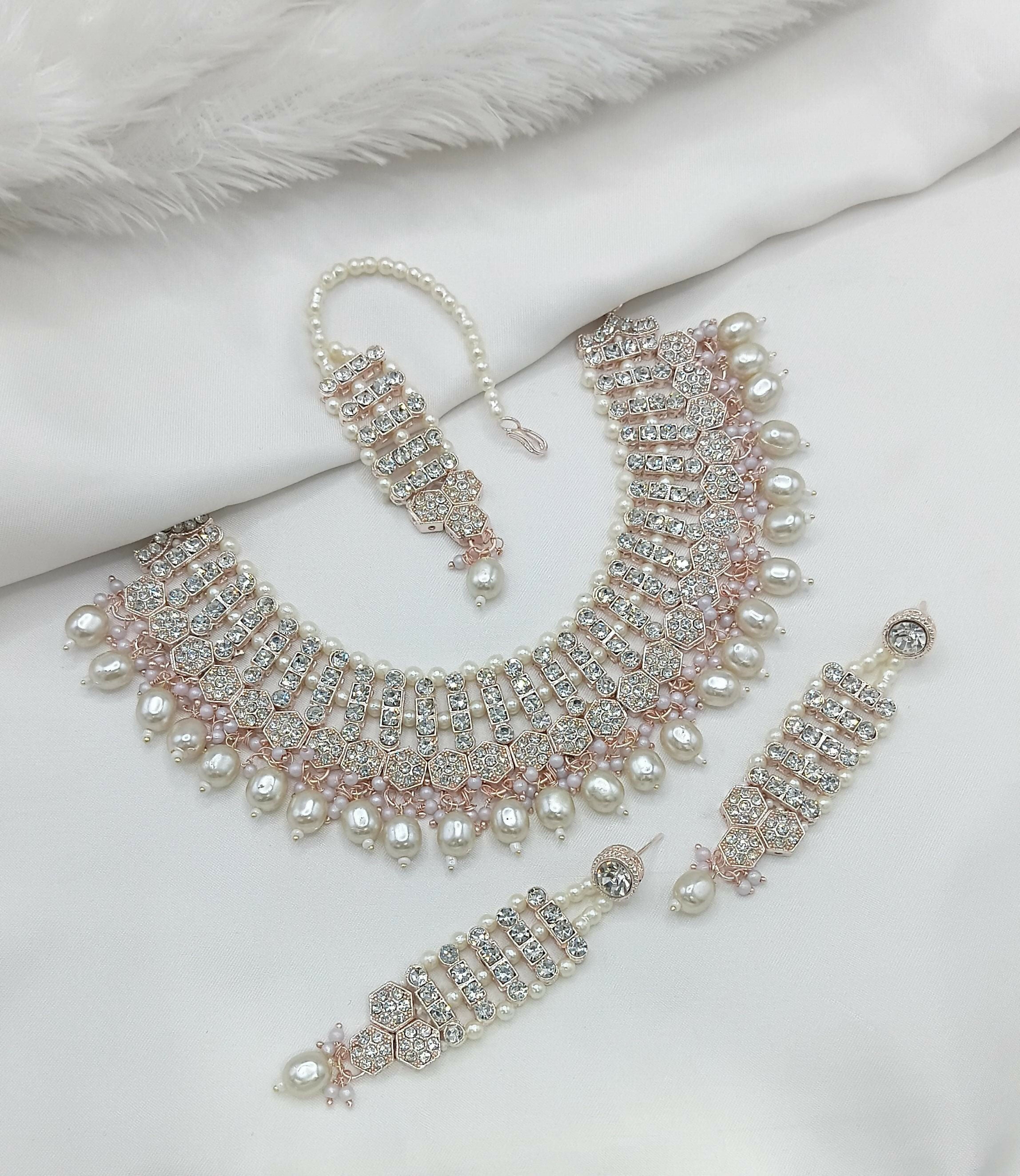 White stone work necklace set with delicate pattern and matching jewelry