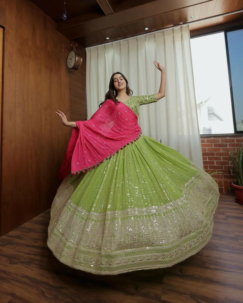 A dark green faux georgette lehenga choli set heavily embellished with sequins and delicate thread embroidery.