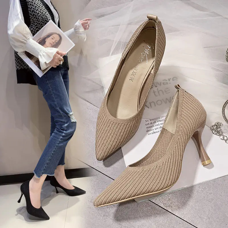 A pair of beige pointed toe knitted heels with a slim heel shown from the side on a white background.