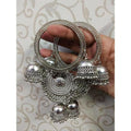 Heavyweight silver-tone bridal bangles featuring large dangling jhumka latkans