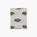 Begum hand-printed linen table runner in pink and green floral motif on a white background