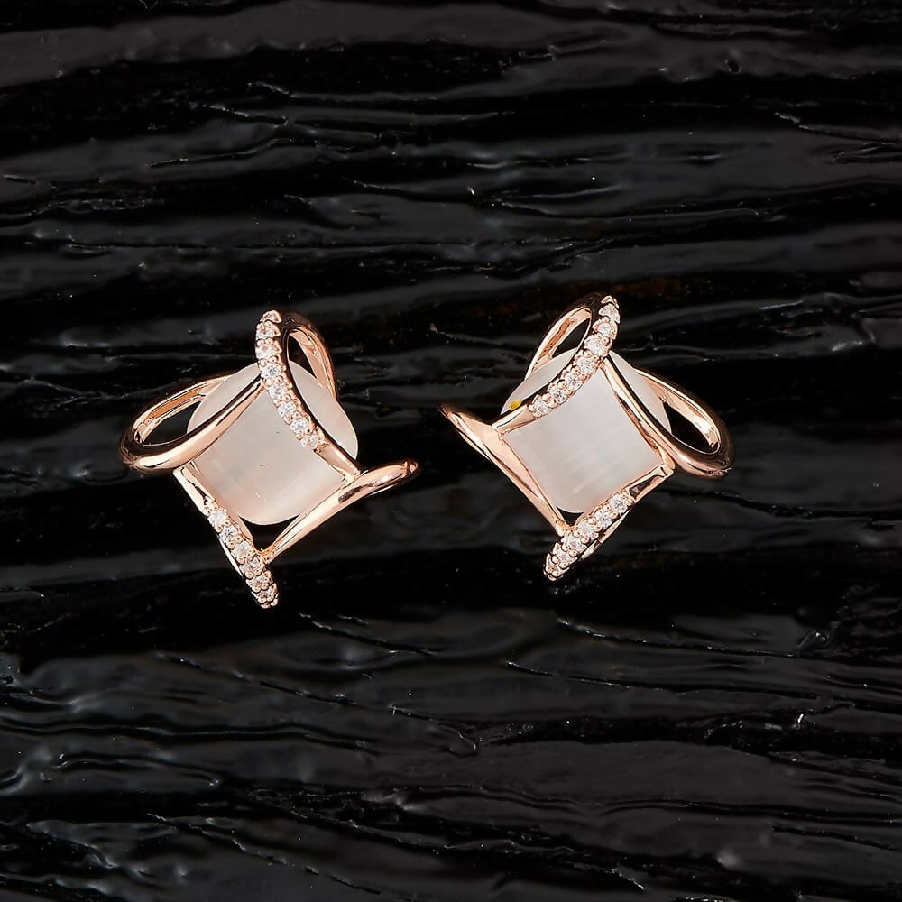 Close-up of Golden White AD stone earrings showing detailed brass craftsmanship.
