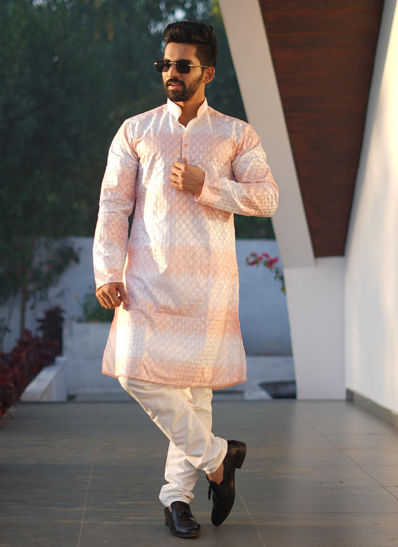 Men wearing a light orange cotton kurta with embroidery and shading print detail