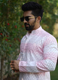 Men wearing a light pink cotton kurta with embroidery and shading print details.