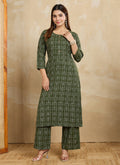 A stylish green printed cotton blend kurta pant set displayed on a model.