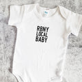 White short sleeve baby bodysuit with RBNY LOCAL BABY text printed in black