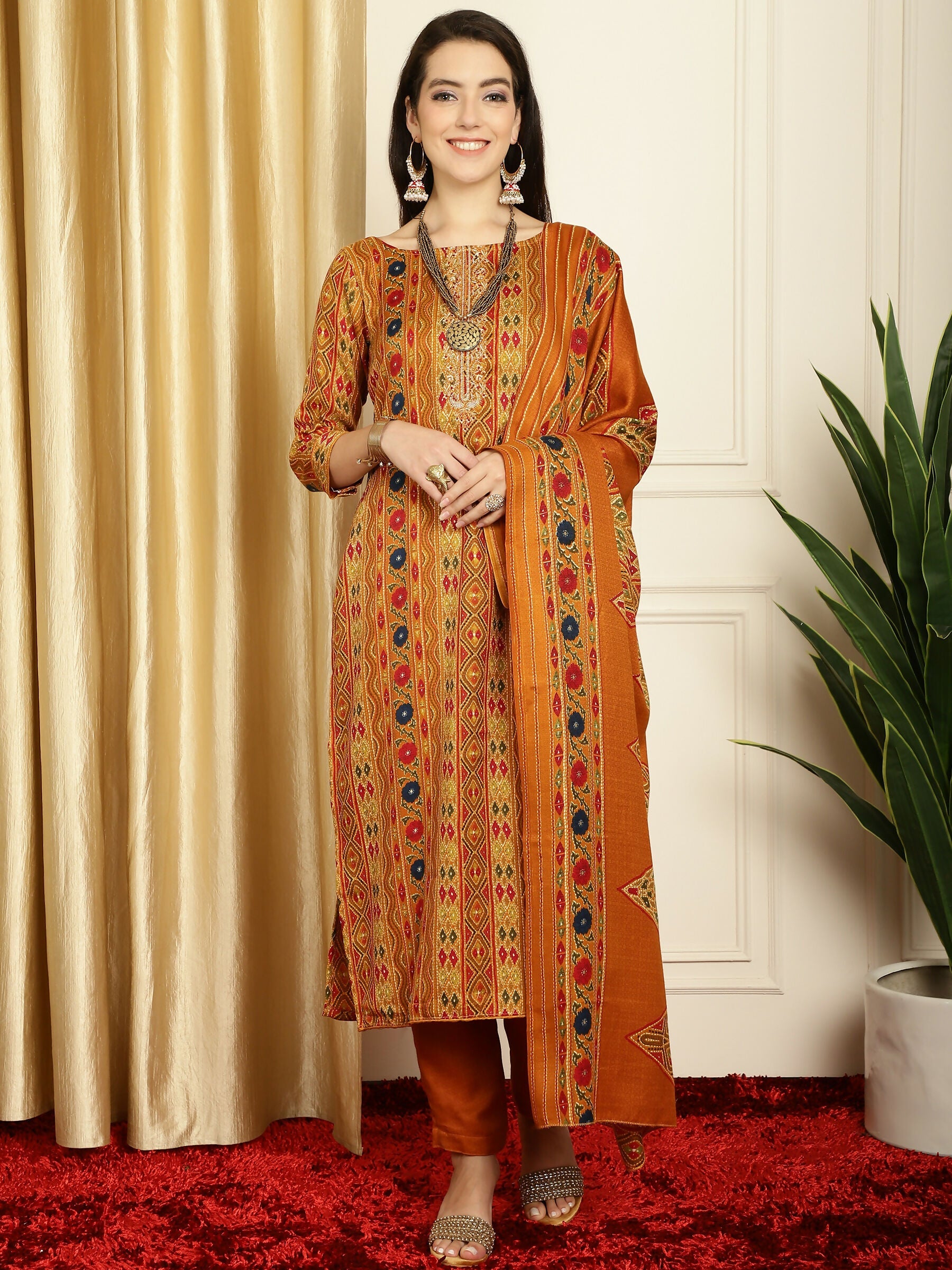 Woman wearing a mustard pashmina kurta set with floral digital prints and a matching dupatta