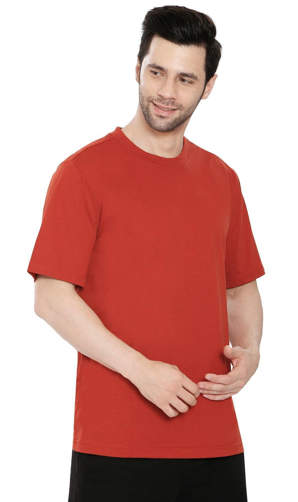 A man wearing a heavyweight relaxed fit crew neck cotton blend t-shirt in a solid color