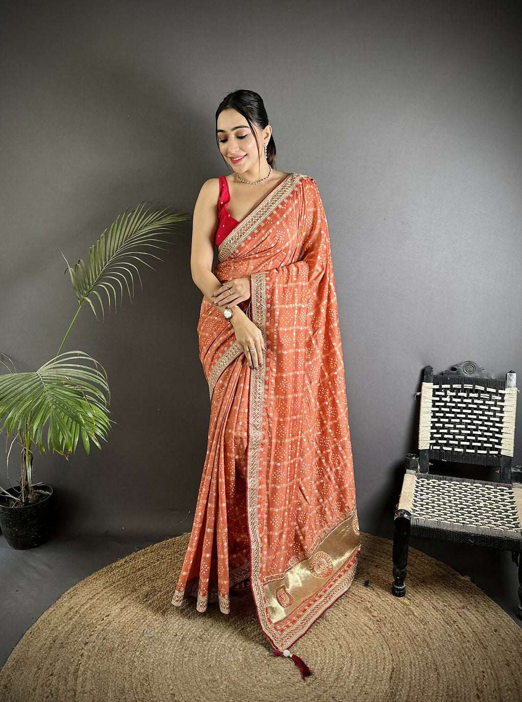 Beautiful peach colored Vichitra silk saree featuring intricate traditional Bandhani prints