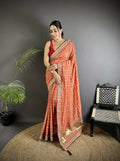 Beautiful peach colored Vichitra silk saree featuring intricate traditional Bandhani prints