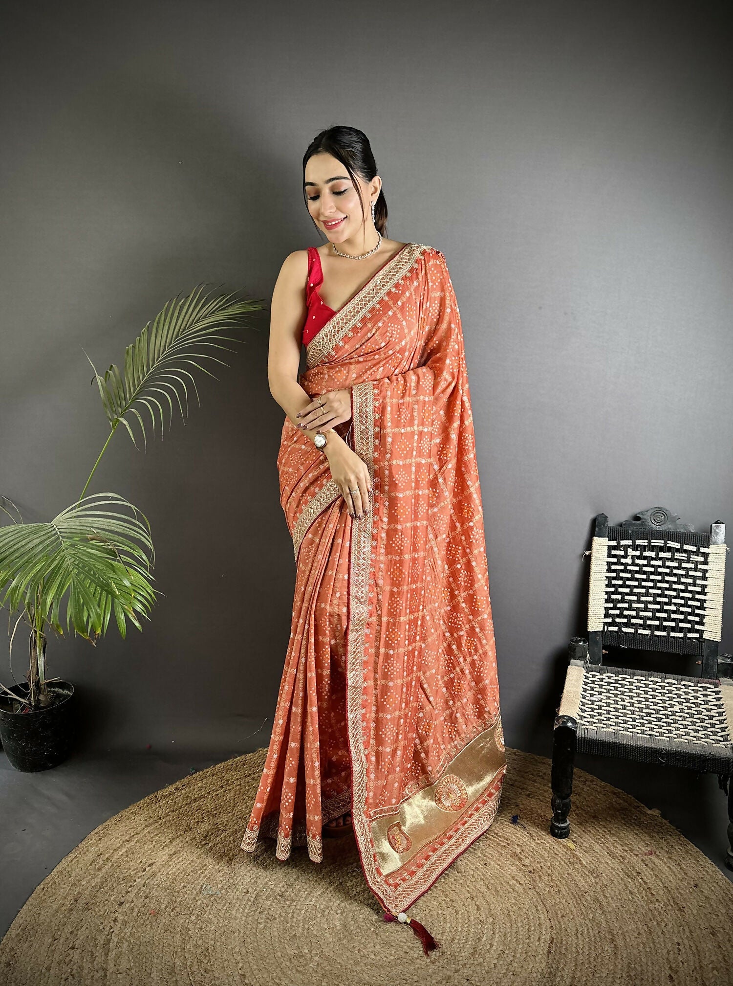 Beautiful peach colored Vichitra silk saree featuring intricate traditional Bandhani prints
