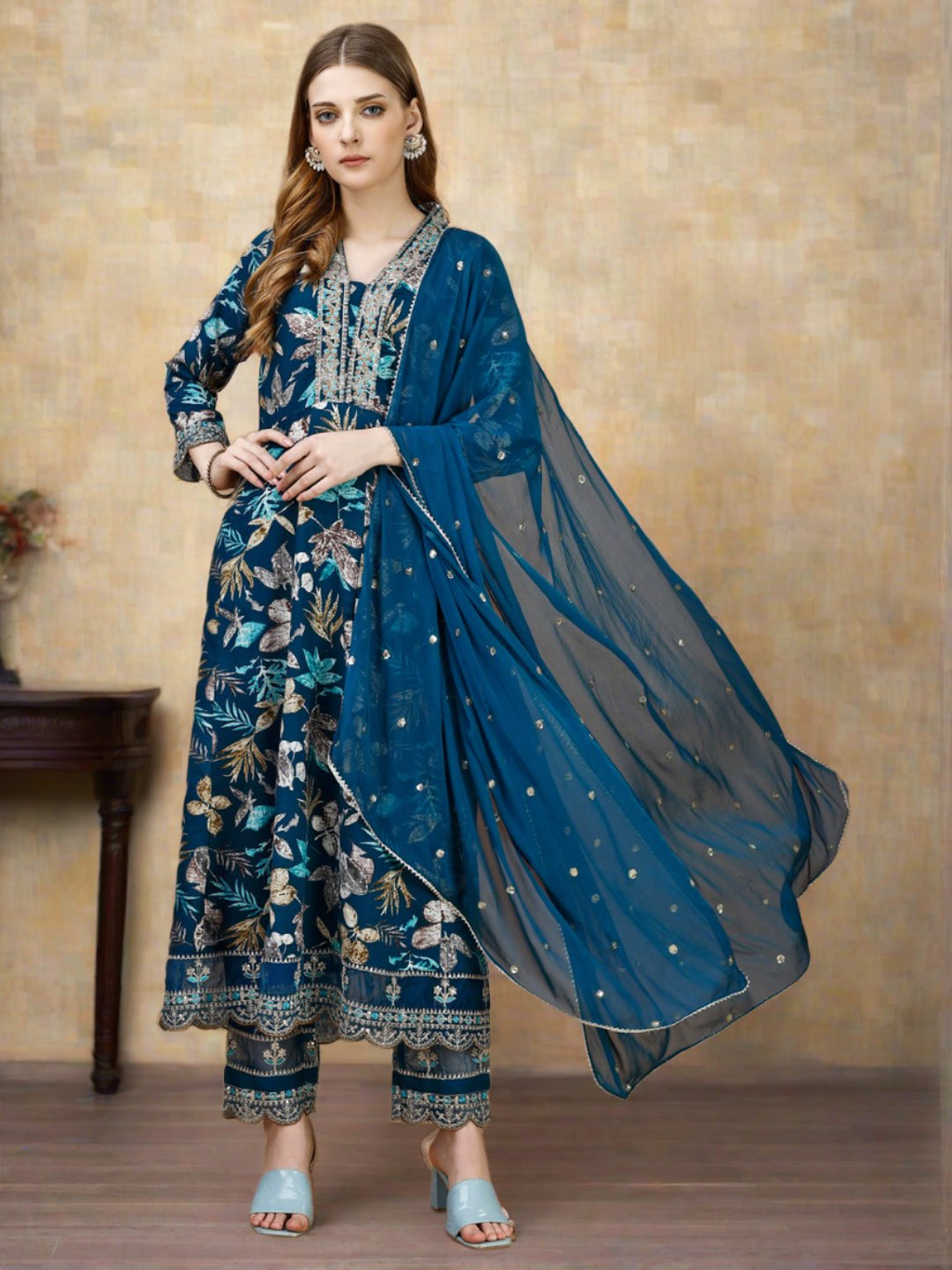 Woman wearing a luxury multicolor floral embroidered Anarkali kurta set with matching pants and dupatta.