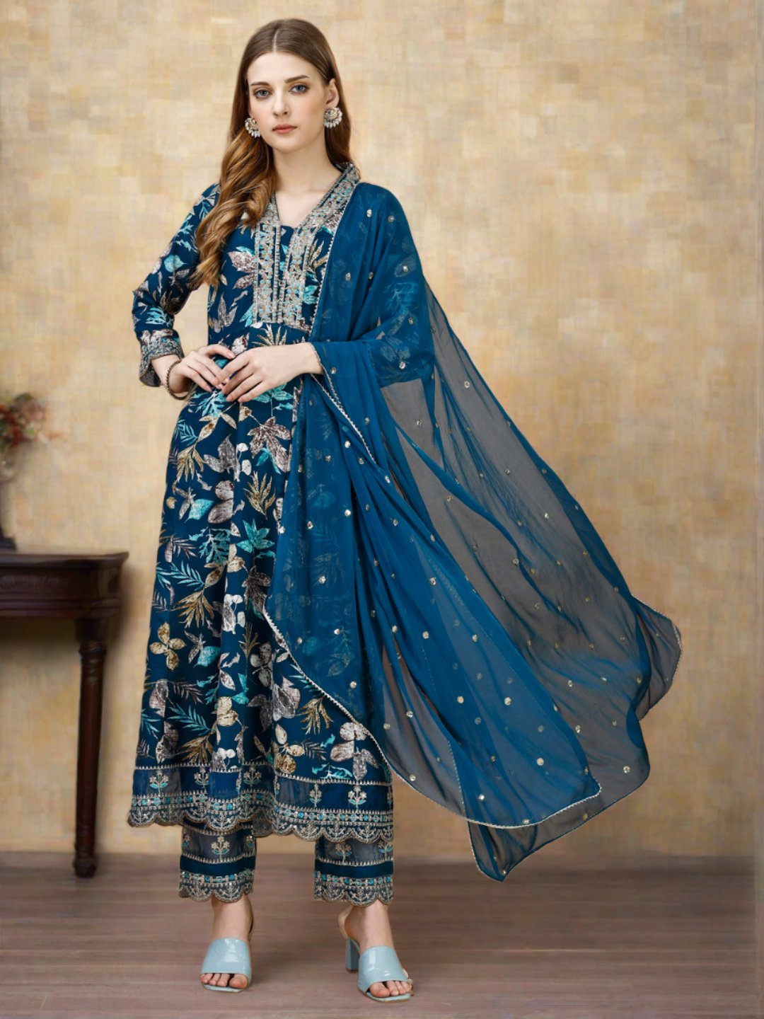 Woman wearing a luxury multicolor floral embroidered Anarkali kurta set with matching pants and dupatta.