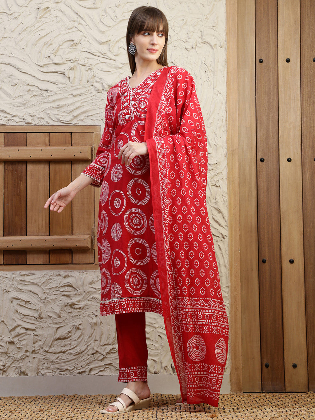 Vibrant red embroidered cotton kurta with printed details, matching pants, and dupatta