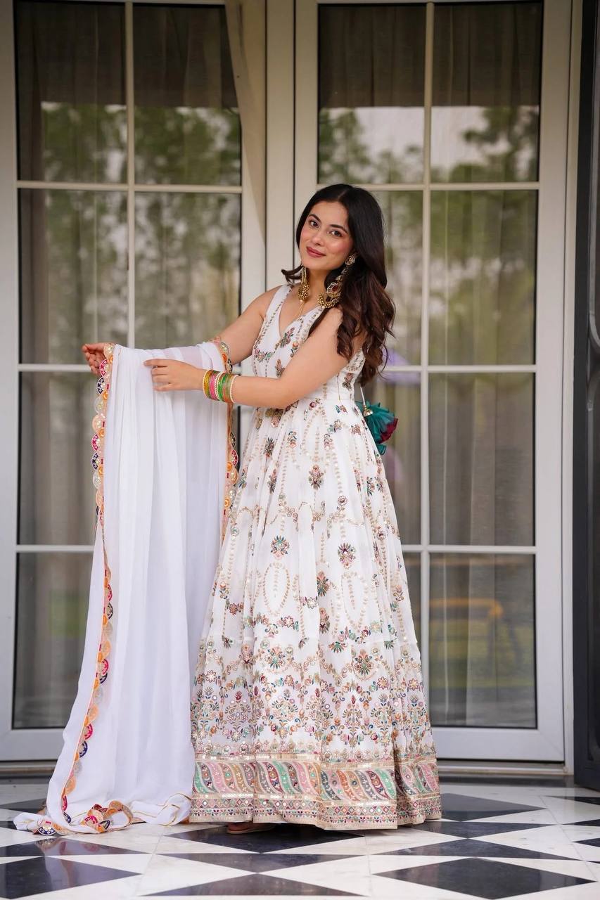 Elegant off-white faux georgette Anarkali suit with detailed thread and sequin embroidery.