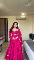 Front view of a pink faux georgette Anarkali suit with intricate thread and sequin embroidery.