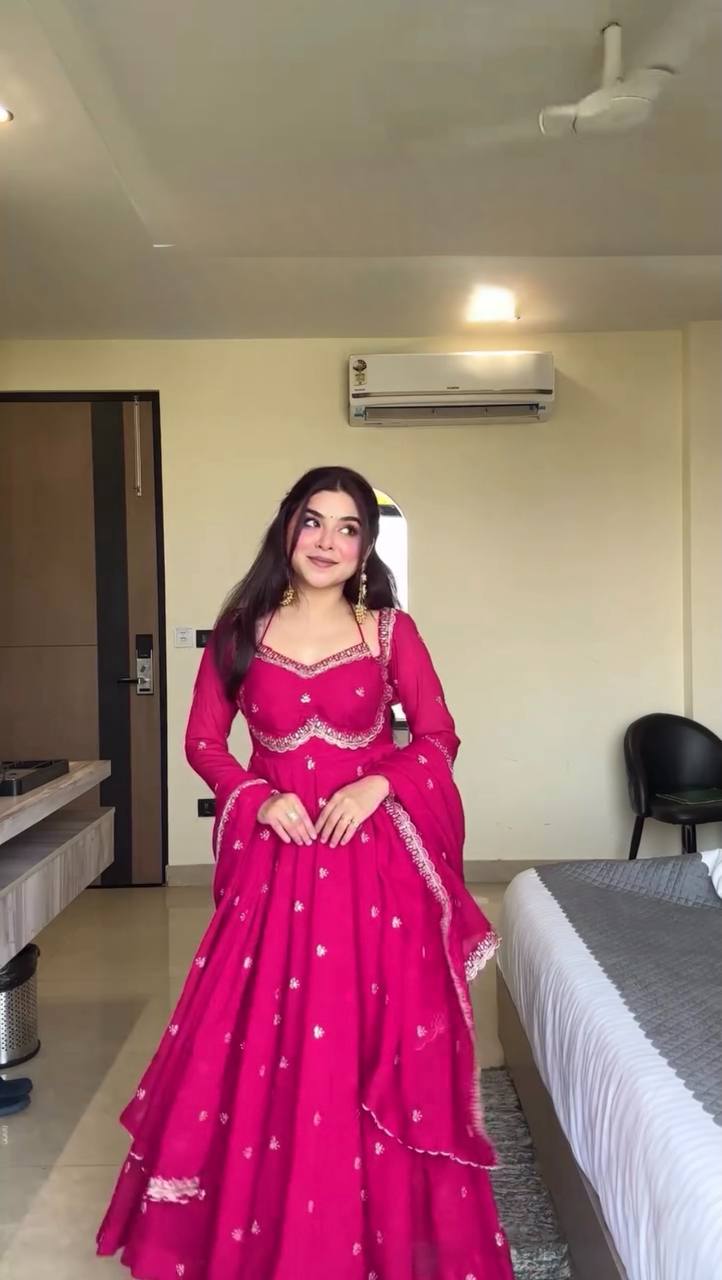 Front view of a pink faux georgette Anarkali suit with intricate thread and sequin embroidery.